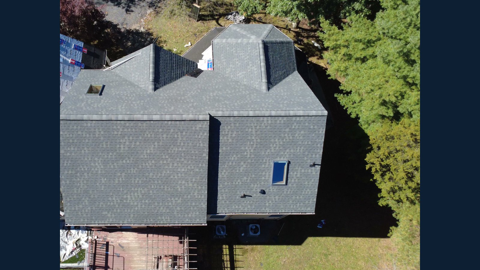 Photo 6 of 10, Shingles going on: Main roof shingled while the next section is still in underlayment