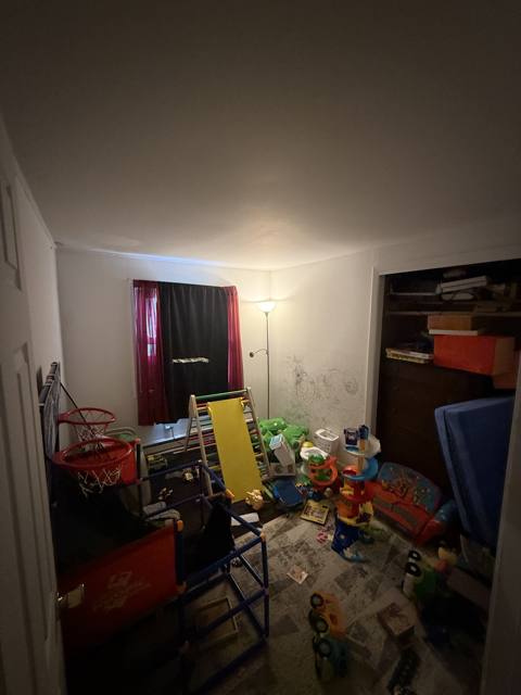 Before: bedroom with red curtains, tall view