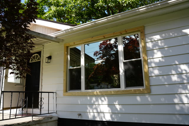 July 24: the porch and front window, new trim going on